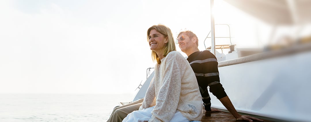man and woman sitting on boat at dock