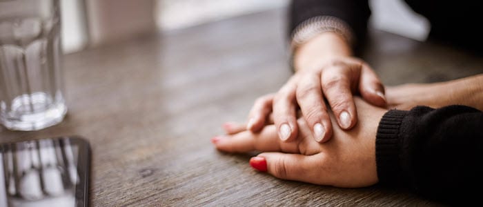 Holding hands on table