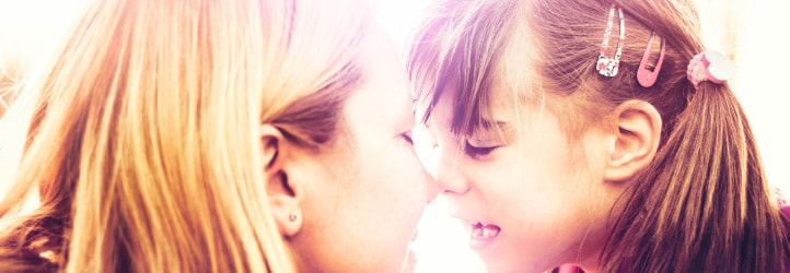 Woman touching noses with daughter