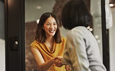 Two women shaking hands